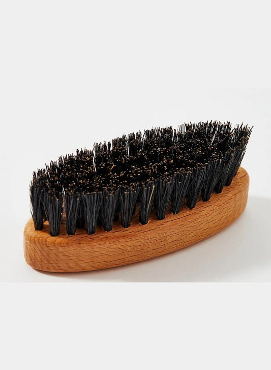 Wooden brush with black bristles on a white background