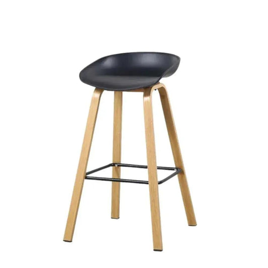 Bar stool with black seat and wooden legs on a white background