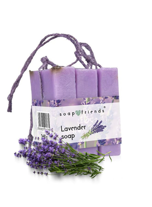Three lavender-colored soap bars tied with a string, labeled as Lavender Soap, with fresh lavender flowers next to them.