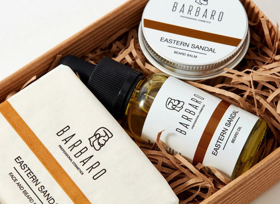 Barbaro grooming products including a bottle, jar, and soap in a wooden box.