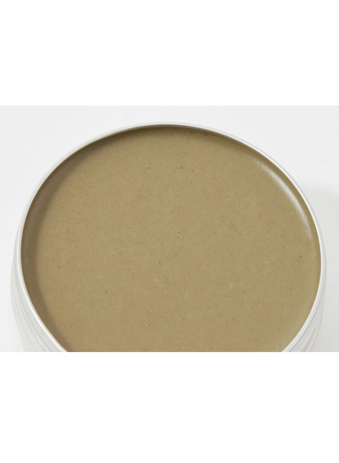 Beige-colored cream in a white container on a white background