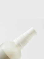 White spray bottle on a light gray background