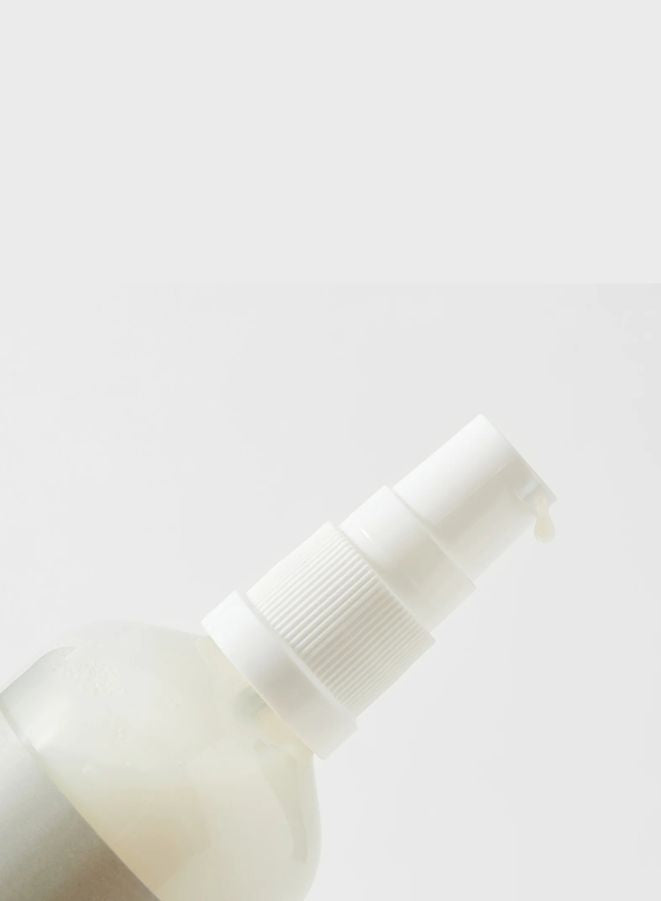 White spray bottle on a light gray background