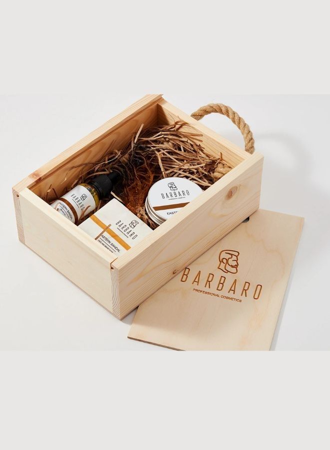 Wooden gift box with skincare products and a brown paper bag featuring 'Barbaro' branding on a white background.