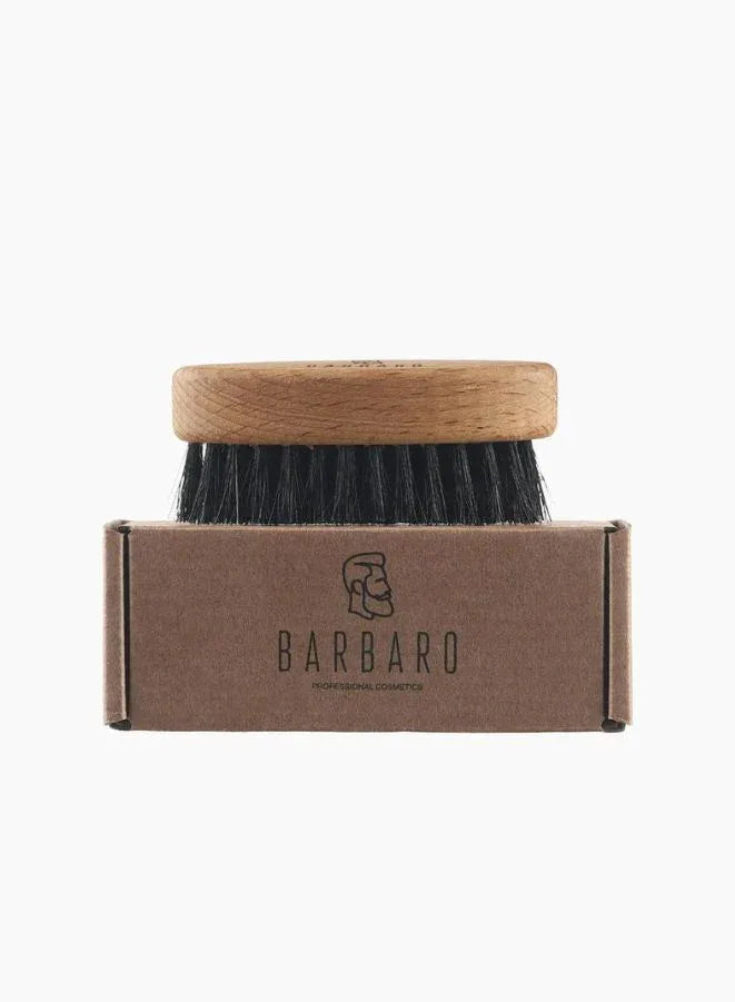 Barbaro brush with wooden handle and black bristles on a cardboard box labeled 'BARBARO' against a white background.