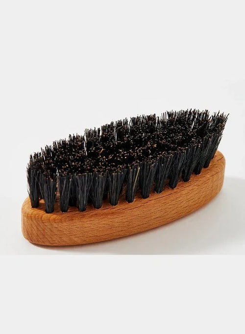 Wooden brush with black bristles on a white background