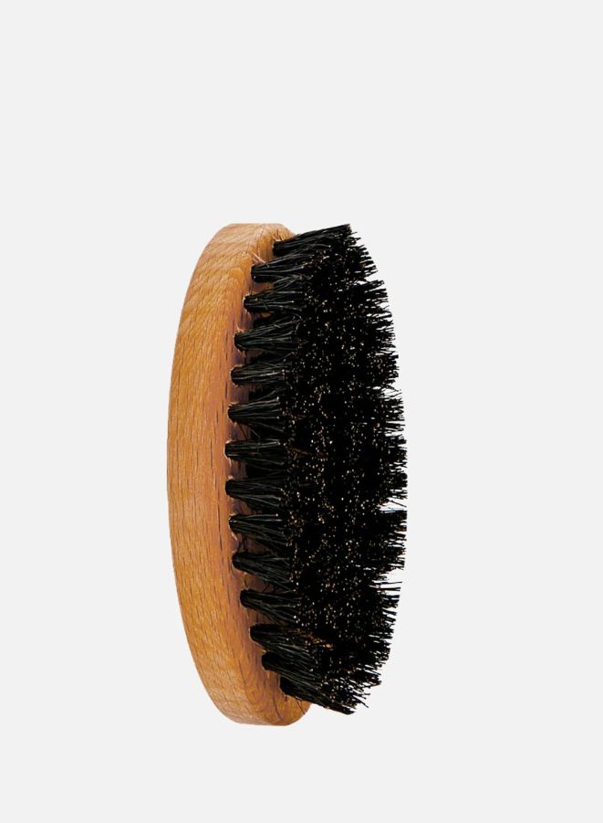 Wooden brush with black bristles on a white background