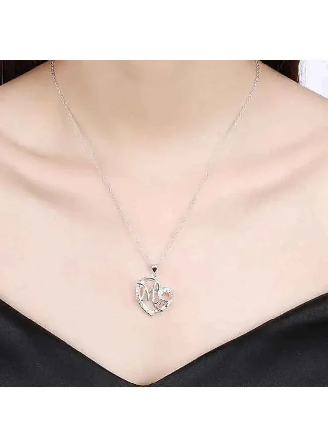 Silver necklace with a heart-shaped pendant on a plain background