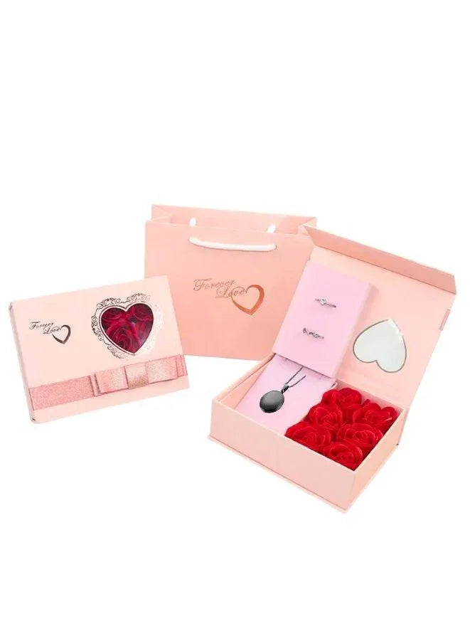 Set of jewelry gift box including a heart-shaped gift box, a black necklace, and a pink box on a white background.