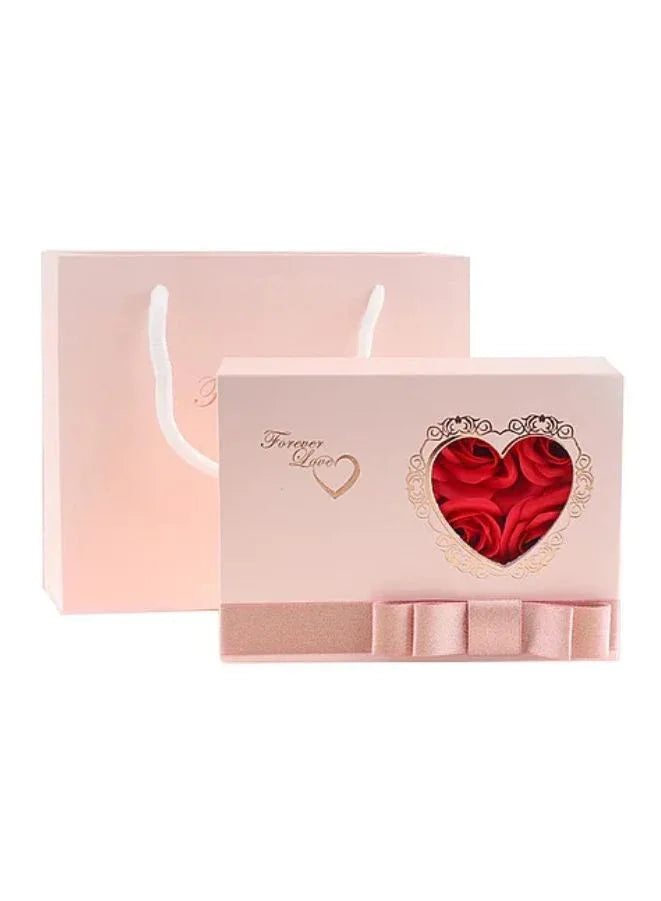 Gift box with a heart-shaped red center in a pink box on a white background
