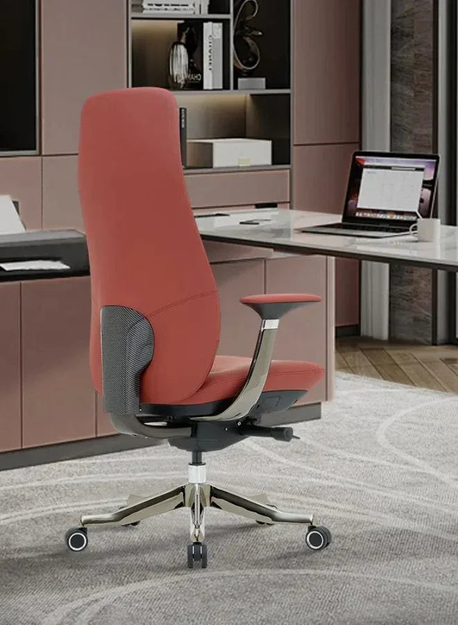 Red office chair in front of a desk with a laptop in an office setting.