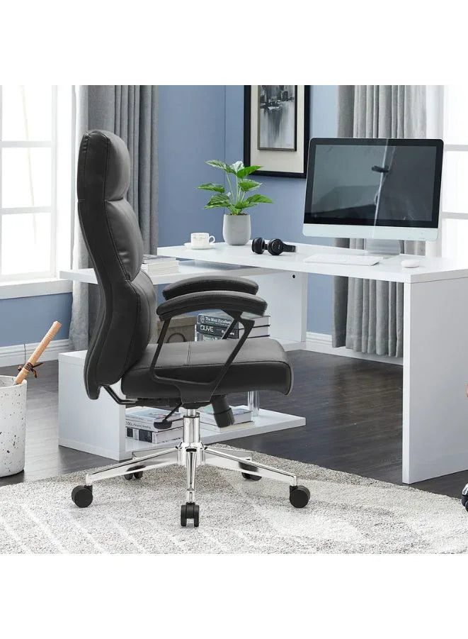 Black office chair in a home office setting with a desk and computer monitor.