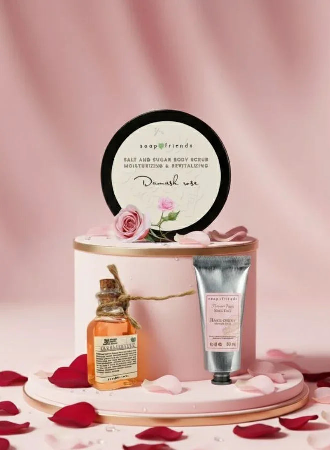 Skincare product set with a bottle, jar, and round container on a pink background with rose petals.