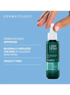 Librederm hyalur Zn bottle with a hand holding it against a blue background