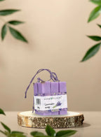 set of lavender soap bar placed on a wooden slice with decorative elements
