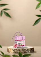 Set of pink soap bars placed on a wooden piece with decorative elements