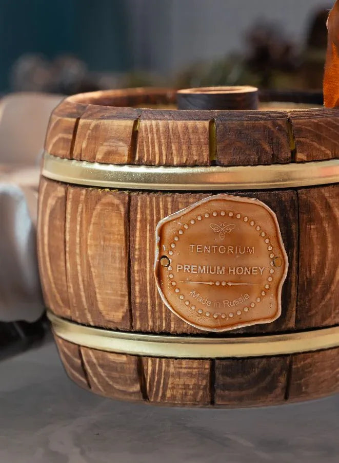 Wooden honey container with Tentorium label on a blurred background