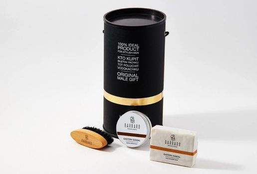 Barbaro grooming products including a black cylindrical container, brush, and soap on a white background